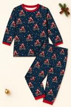 Load image into Gallery viewer, Bicycle Santa navy pajama set flat lay on cream