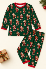 Load image into Gallery viewer, Dancing Santa green pajama set flat lay on cream