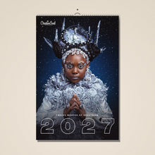 Load image into Gallery viewer, Twelve Months of Greatness 2027 wall calendar hanging on a wall
